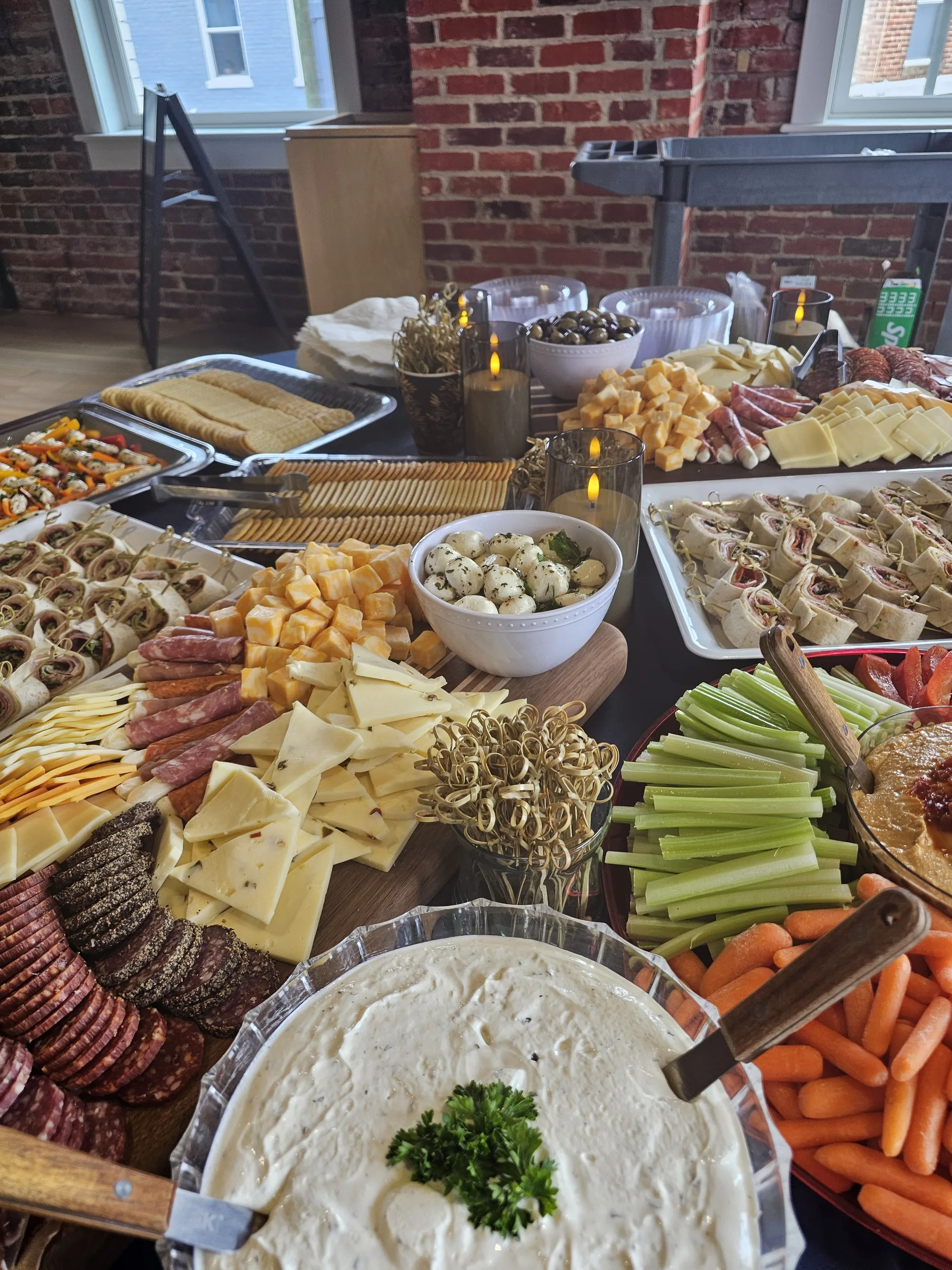 Full buffet assortment with cheese, charcuterie, wraps, and vegetable trays catered by Global Fusion RVA