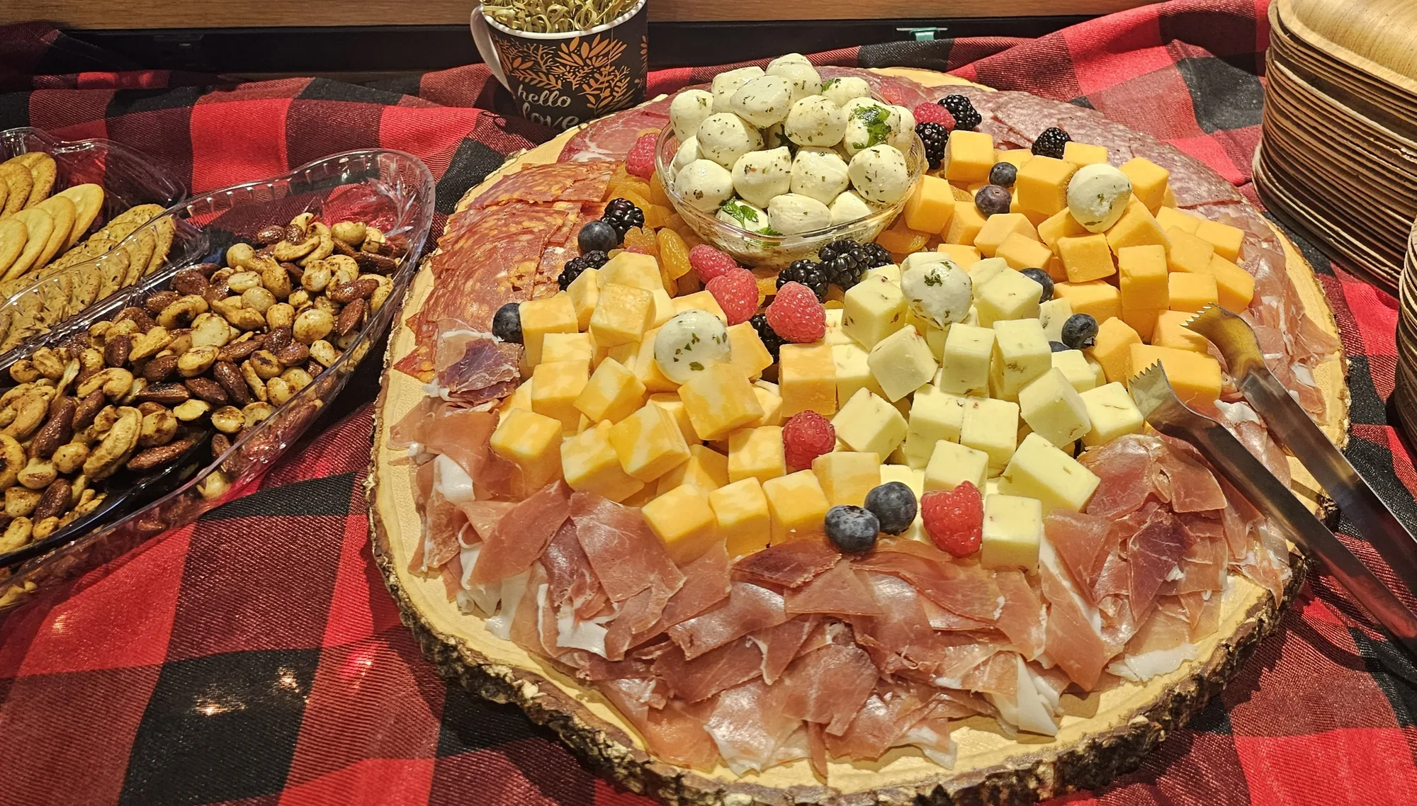 Charcuterie platter with prosciutto, cheese cubes, and marinated mozzarella at a catered event