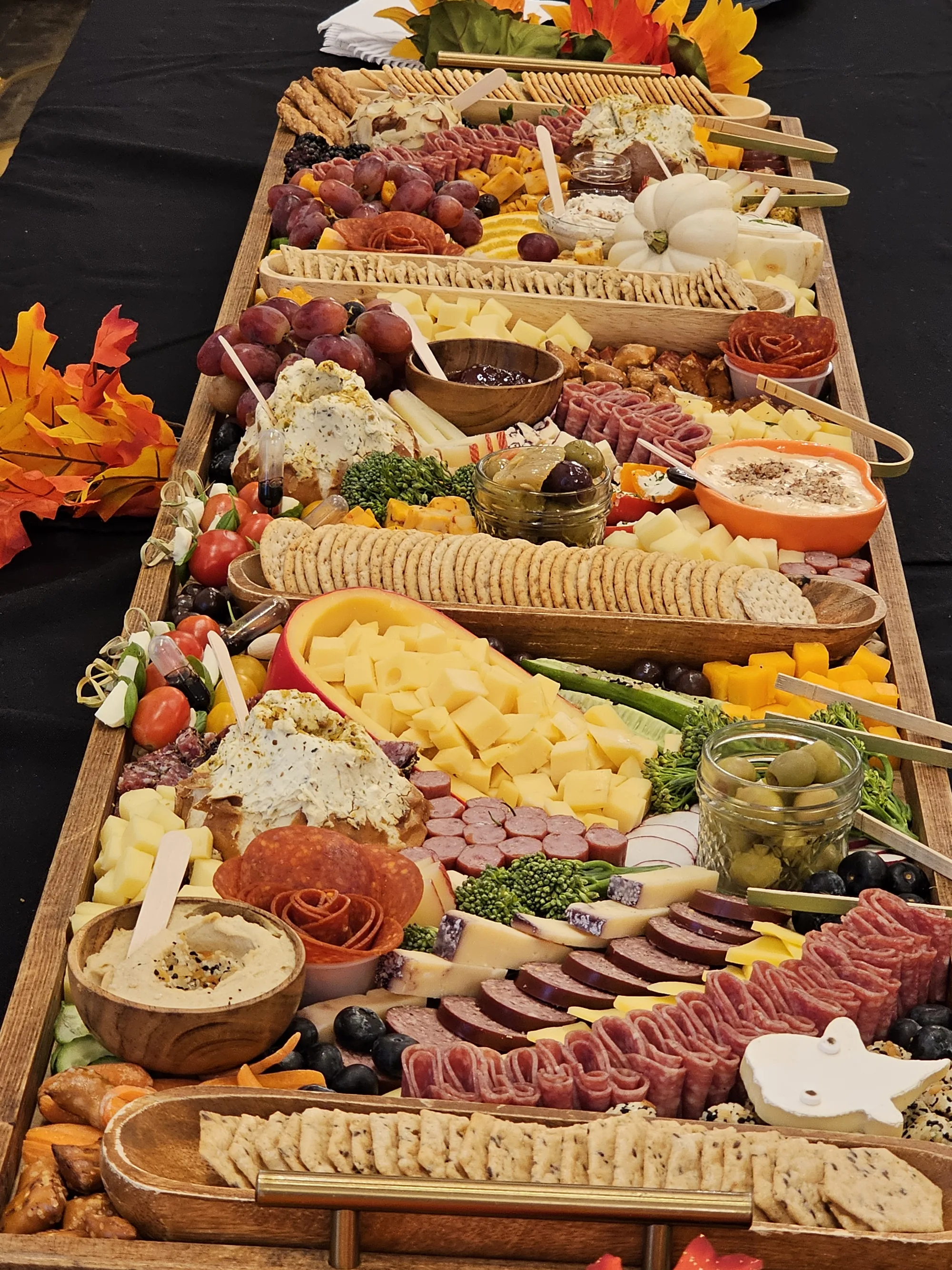 Large grazing table spread with charcuterie, cheese, fruit, and crackers for a Global Fusion RVA catering event