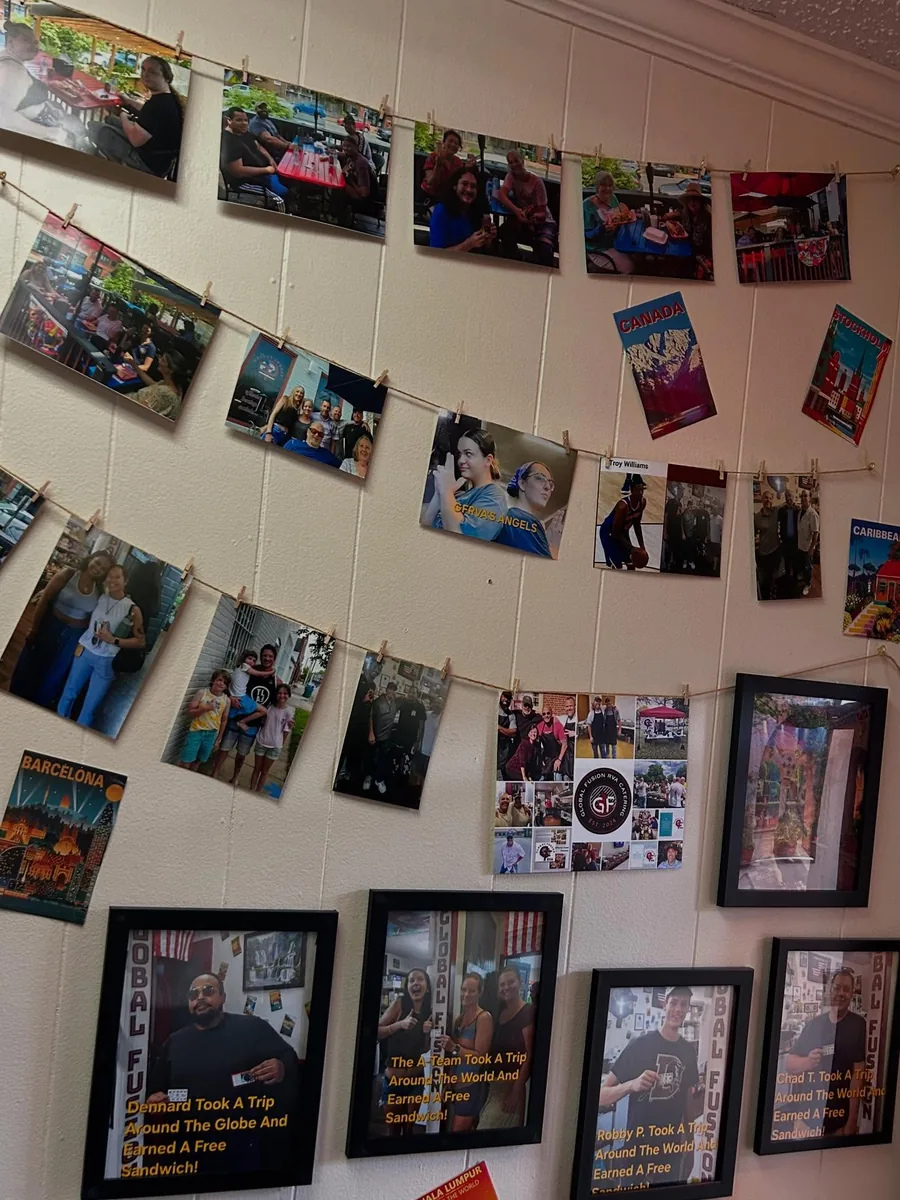 A wall of photos and mementos from Global Fusion RVA's history, including team and event pictures