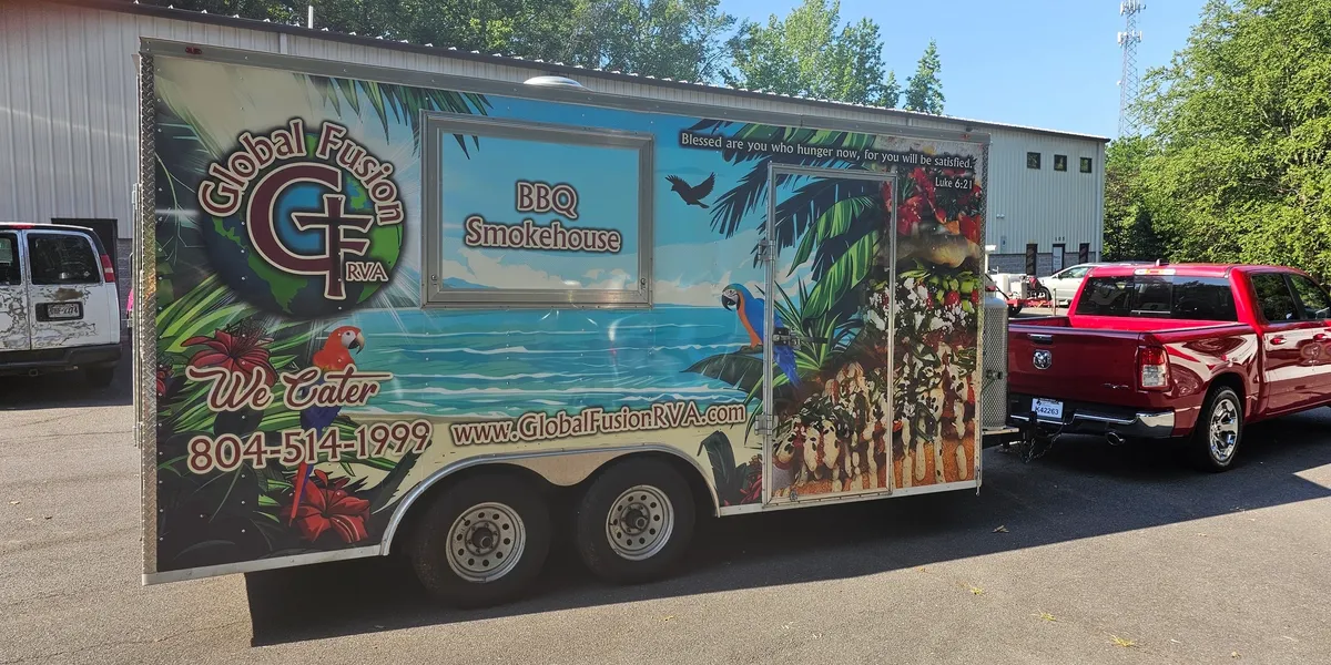 Global Fusion RVA's red pickup truck towing the branded food trailer to its next location